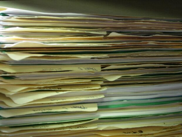 Photo of a pile of paperwork by Tom Ventura from Wikimedia Commons (used under a Creative Commons licence).