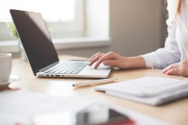 woman typing on a laptop